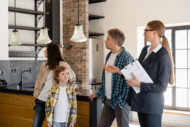 Property manager showing a rental home to a family of two adults and a child